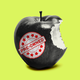 A sticker that says "pre-owned: on an apple that's been bitten into